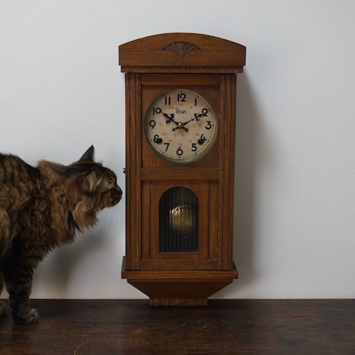 A wooden wall clock made in Japan around 1950